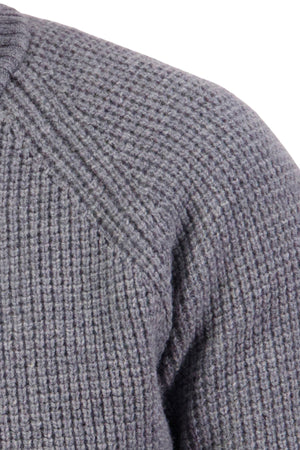 Close-up of the Swanndri Chalky Island Waffle Jumper in gray lambswool, showcasing its textured waffle knit pattern and shoulder seam detail against a white background.