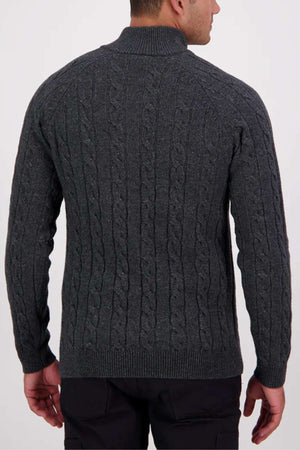 A man is seen from behind wearing a dark gray Swanndri Doncaster v2 Zip Cable Knit sweater with a high collar, standing against a plain, light background.
