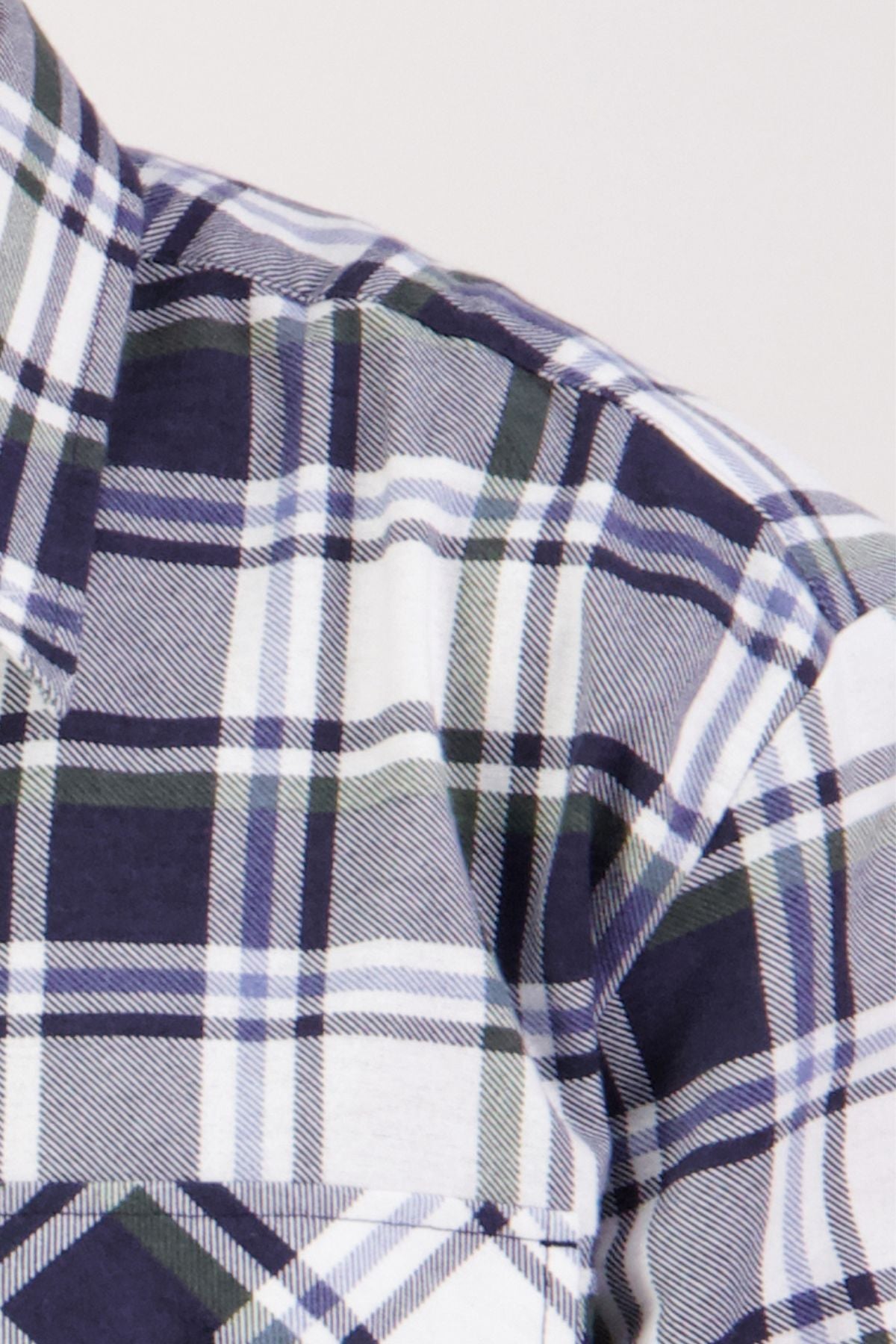 Close-up of the Swanndri Egmont Flannelette Twin Pack shirt in soft, brushed cotton with a blue, white, and black plaid pattern, highlighting the upper shoulder and chest of this classic long sleeve design.
