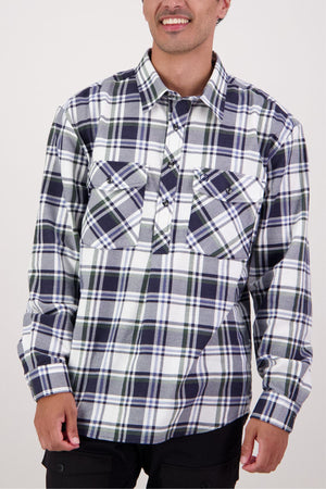 A person wearing a Swanndri Egmont Flannelette Twin Pack long-sleeve navy and white plaid shirt with buttoned chest pockets, standing against a plain light background.