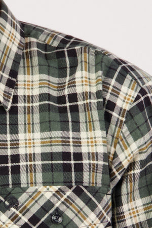 Close-up of the Swanndri Egmont Flannelette Twin Pack: green, black, and white plaid long sleeve shirt with a buttoned chest pocket and collar, made from durable flannelette fabric with multicolored intersecting lines.