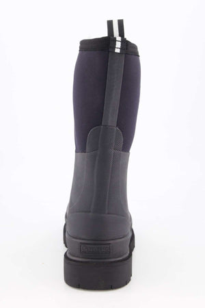 The Grubs Fenline Mid Work Boot has a tall design with a black rubber sole and dark gray upper for superior grip. It features two pull tabs on top, one with a white stripe, and textured detailing on the heel for added style and function.