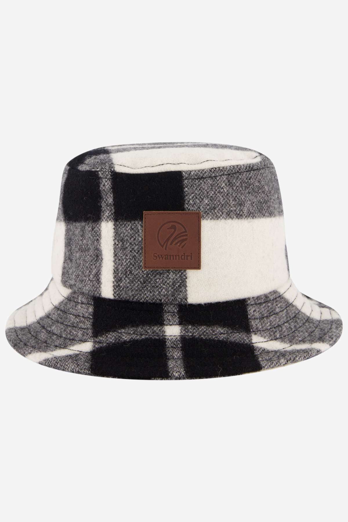The Swanndri Kaimai Wool Bucket Hat features a black, white, and gray plaid pattern with a brown leather patch showcasing the Swanndri logo—ideal for your next outdoor adventure.
