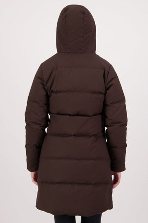 A person is seen from behind wearing the Swanndri Nimbus Longline Down Coat with a hood, arms at their sides, standing against a plain light background.