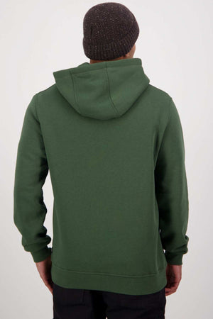 An individual sporting the Swanndri Original V2 Hoodie, made from a dark green cotton and polyester blend, along with a gray knit beanie, is viewed from behind. The plain, light background draws attention to the hoodie’s distinctive kangaroo pocket. The person stands straight with their hands at their sides and the hood down.