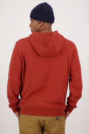 A person wearing a red Swanndri Original V2 Hoodie, khaki pants, and a navy knitted beanie is shown from the back against a plain white background.