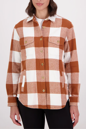 A person wearing the Swanndri Rapaki Long Sleeve Shacket in brown and white plaid (100% brushed cotton) stands against a plain light background. Only the torso and part of the arms are visible; ideal as a winter layer.