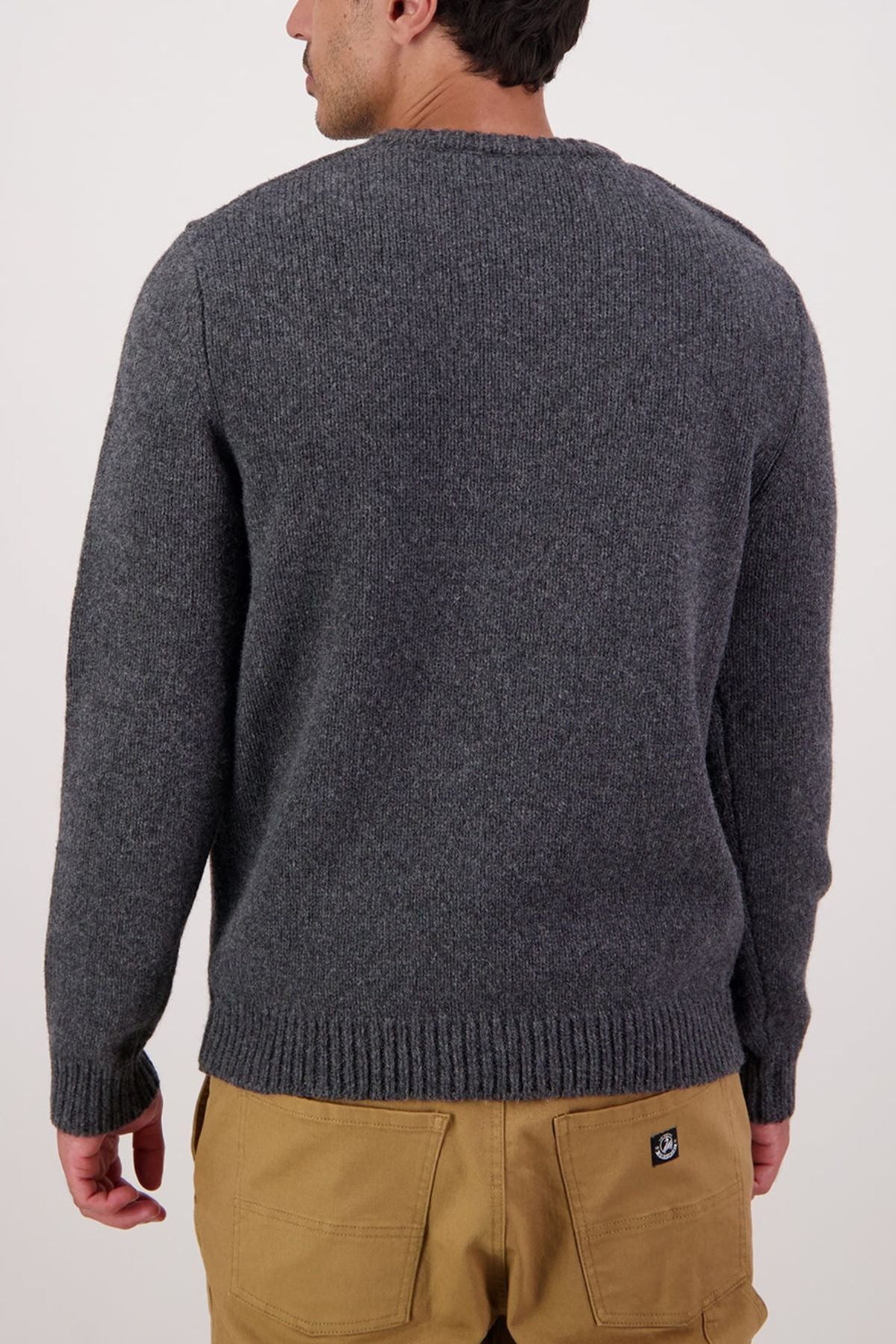 A person is shown from the back wearing a Swaandri Waylins Wool Knit Crew in grey with tan pants, set against a plain light background.