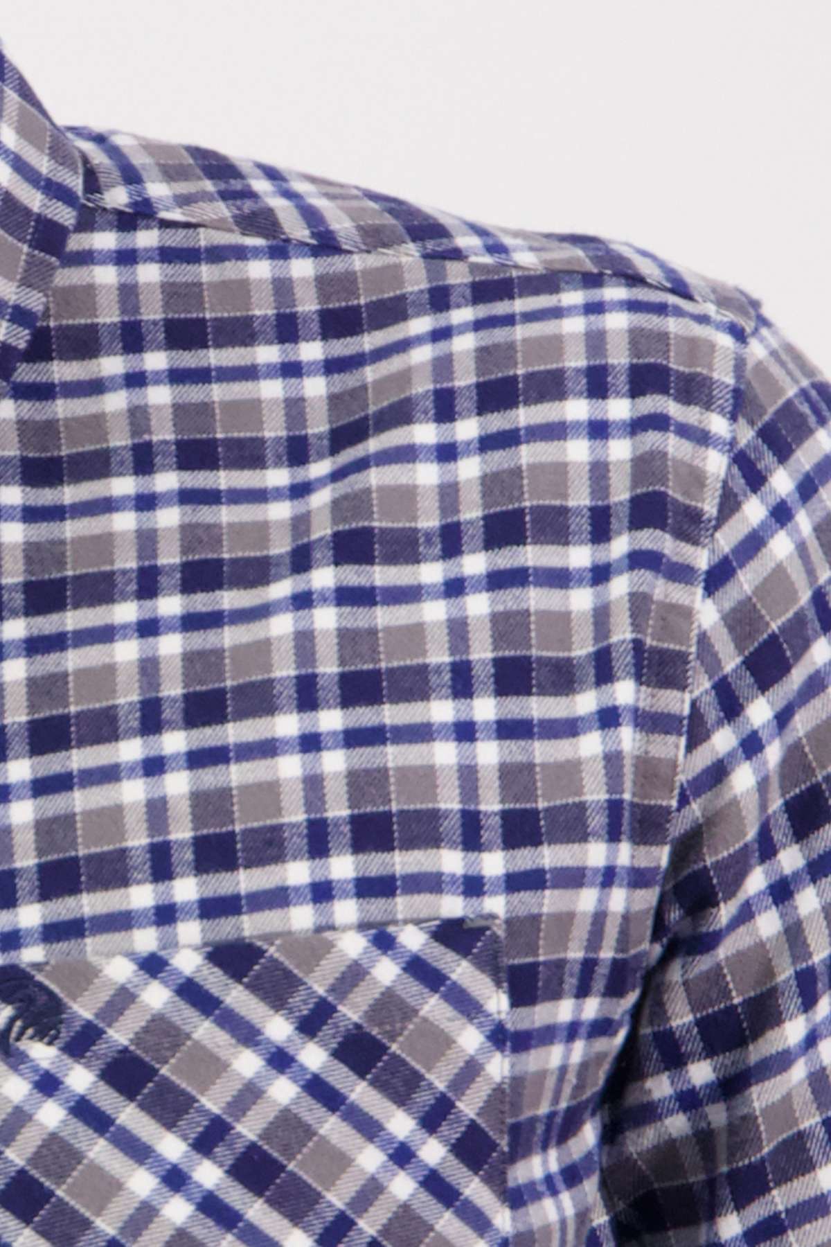 Close-up of the Swanndri Wendon Shirt in blue, white, and gray plaid, featuring a classic fit and front pocket. Made from 100% cotton, this piece showcases a timeless tartan pattern.