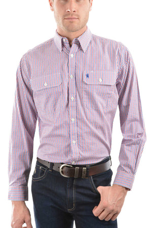 A man wears a Thomas Cook Wentworth Shirt—a long-sleeve, red, white, and blue check 100% cotton button-up with front pockets and chest logo embroidery—paired with dark blue jeans and a brown belt.