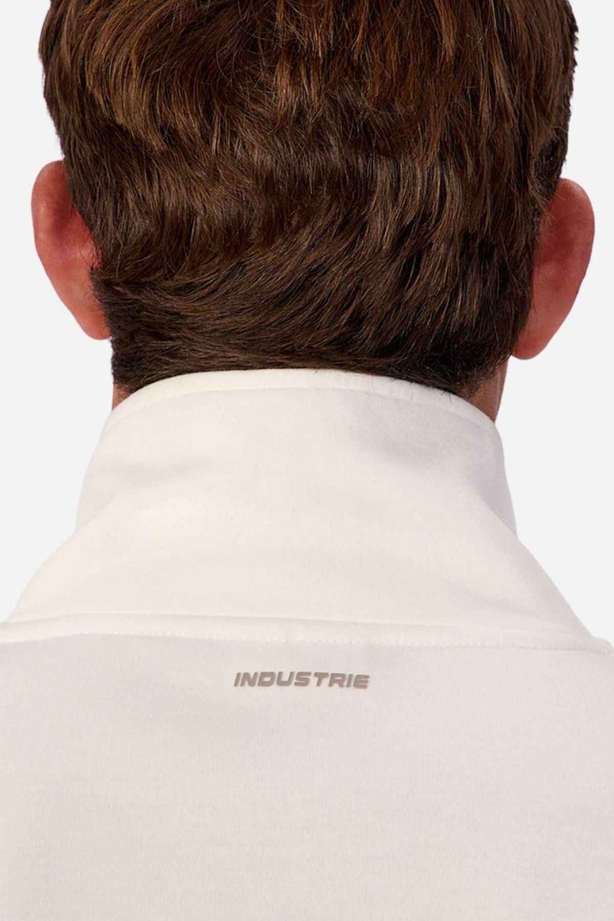 A person with short brown hair is seen from behind wearing the Industrie The Tech Southend Track Top, featuring a white collar and “INDUSTRIE” in grey below it for a clean, casual style.