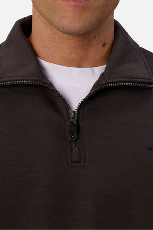 Close-up of a person wearing the Industrie The Tech Staunton Track Top over a white crew-neck shirt. Only the lower face and upper chest are visible, with the track top's zipper partially open.