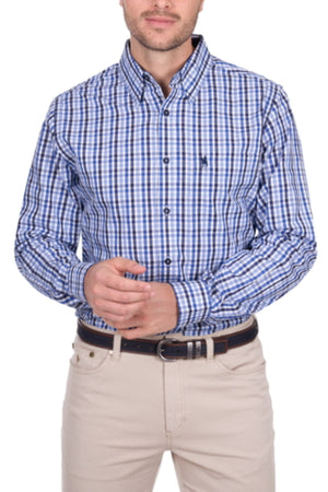 A man wears a blue and white checkered Thomas Cook Andrew Shirt with beige pants and a black belt, posing with hands loosely clasped in front. His head is partially visible.