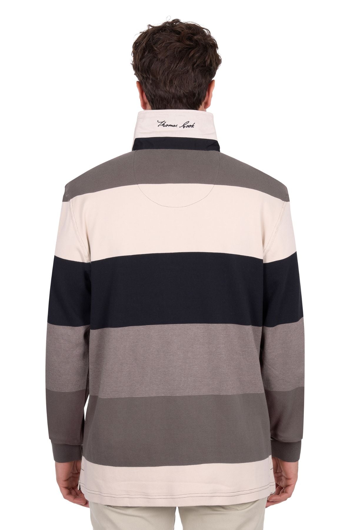 A person is seen from behind wearing the Thomas Cook Brandon Rugby, a long-sleeve shirt with wide beige, gray, and black stripes and a high collar featuring embroidered cursive text.