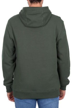 A person is seen from the back in a dark green Thomas Cook Heritage C N C Hoodie and blue jeans, standing against a plain white background.