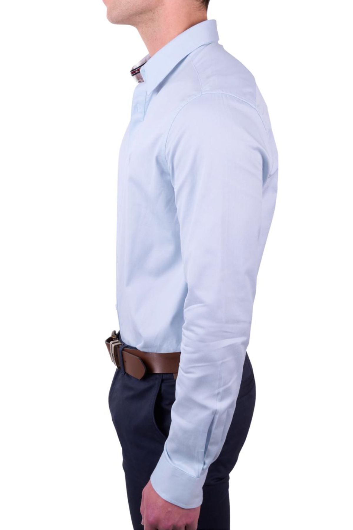 A man in a light blue Thomas Cook Callum Tailored Shirt made from premium woven fabric, paired with dark trousers and a brown belt, is shown in side profile against a plain white background.