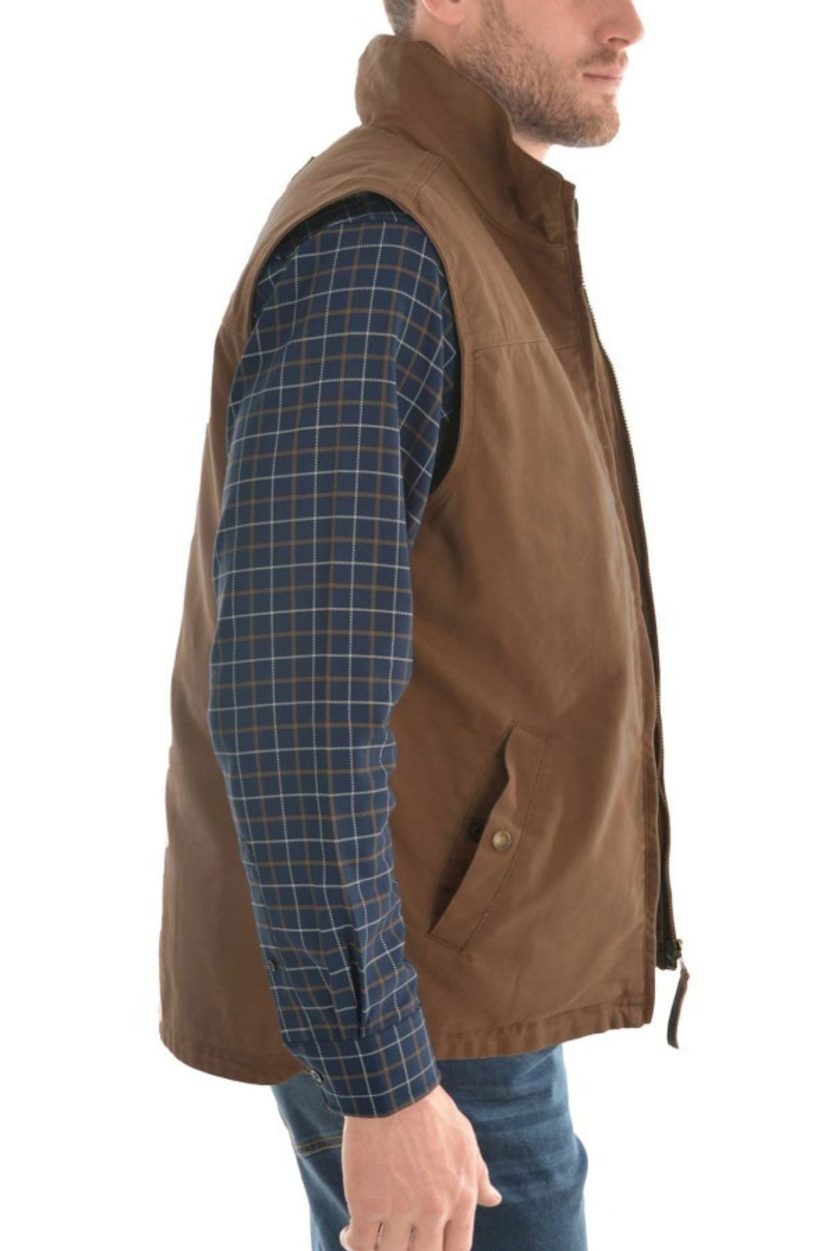 A man wearing a blue plaid shirt and the Thomas Cook Canvas Vest with sherpa lining stands sideways against a white background.