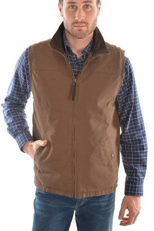 A man wearing a blue plaid shirt and the Thomas Cook Canvas Vest with soft sherpa lining, one hand in his pocket, paired with classic blue jeans.