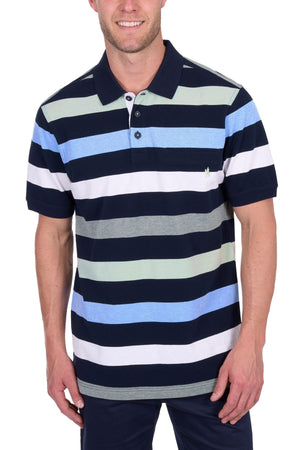 A man wears the Thomas Cook Charles Polo, a multi-colour stripe polo in navy, white, light green, grey, and light blue. Made from 100% cotton pique with a buttoned collar. His face is partially visible as he stands with hands at his sides.