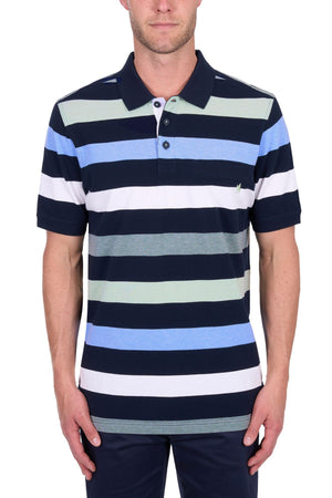 A man wears the Thomas Cook Charles Polo in navy, white, light blue, and light green 100% cotton pique stripes, paired with dark pants.