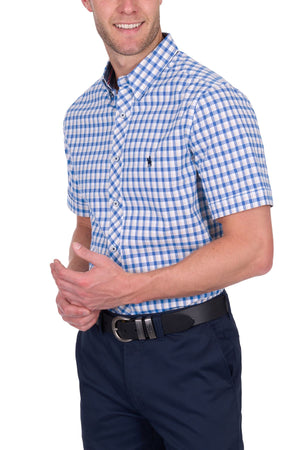 A man wearing the Thomas Cook Chris Tailored Short Sleeve Shirt stands against a white background, his hands clasped loosely in front of him.