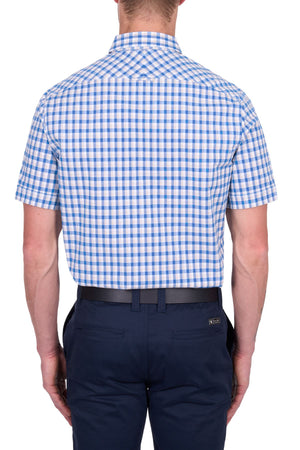 A man is seen from the back against a plain white background, wearing the Thomas Cook Chris Tailored Short Sleeve Shirt in blue and white checks with dark blue pants.