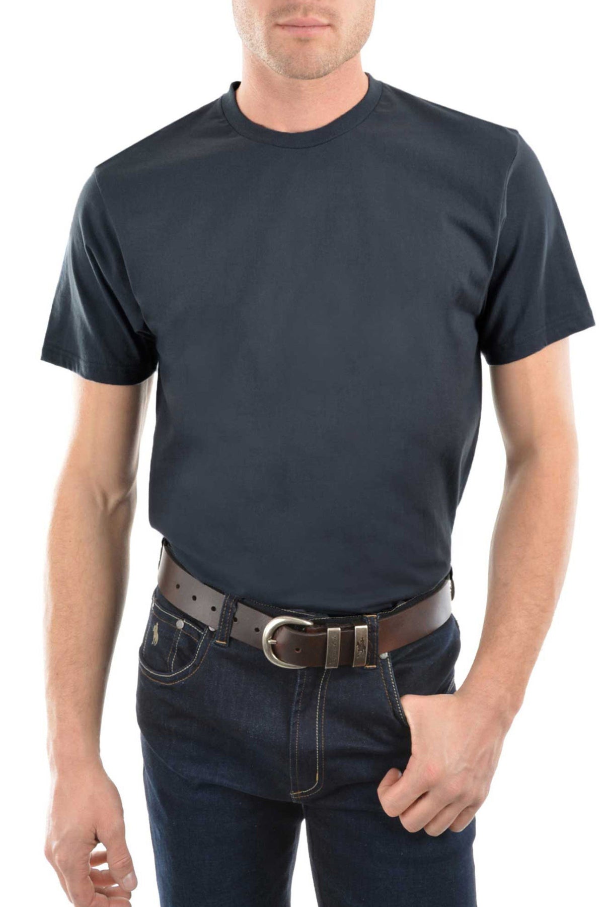 A man in a plain dark navy blue Thomas Cook Classic Fit Tee, crafted from 100% combed cotton jersey, paired with dark jeans and a brown leather belt stands with one hand in his pocket against a white background.