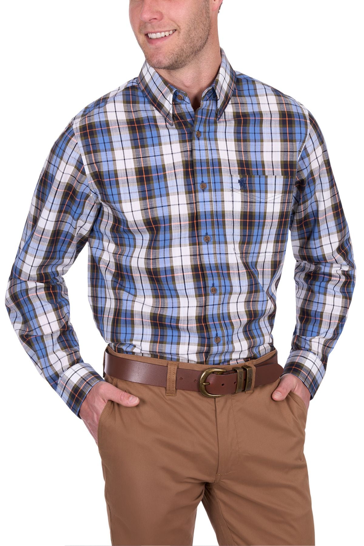 Smiling man wears the Thomas Cook Daniel Shirt, a blue, white, and black yarn dyed check long-sleeve shirt, paired with khaki pants and a brown belt, standing with one hand in his pocket.