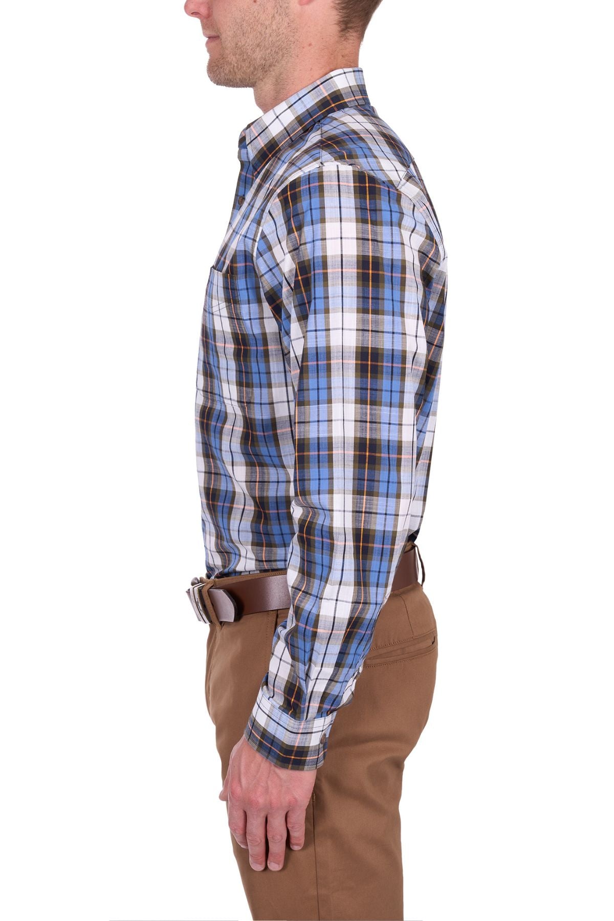A man in profile wears the Thomas Cook Daniel Shirt, a blue, black, and white yarn-dyed checked long-sleeve shirt tucked into brown pants with a brown belt, standing against a white background.