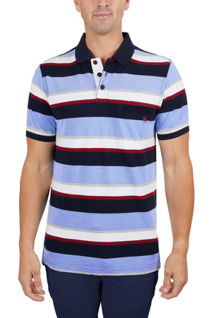 A man in a Thomas Cook Gavin Polo, made of 100% cotton with blue, white, black, and red horizontal stripes, paired with dark pants, stands facing forward against a white background.
