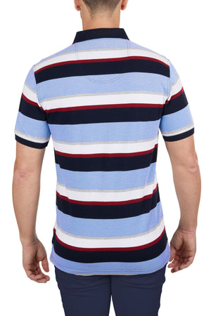 A man is seen from behind wearing the Thomas Cook Gavin Polo, a 100% cotton multicolour stripe polo in light blue, navy, white, and red, paired with dark pants.