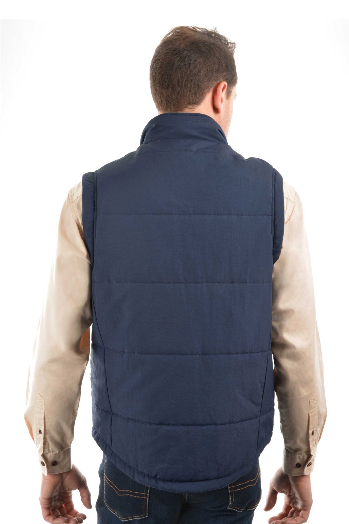 A man stands with his back to the camera, wearing a beige long-sleeve shirt and a navy blue Thomas Cook Hawkesbury River Vest featuring polar fleece-lined pockets, set against a plain white background.
