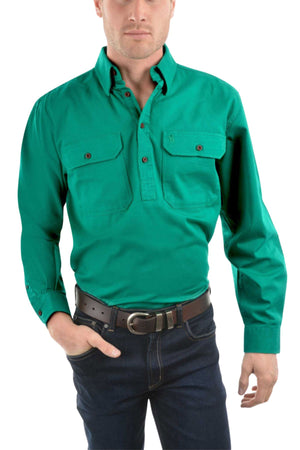 A man stands against a white background, wearing the Thomas Cook Heavy Drill Half Placket Shirt in bright green, paired with dark jeans and a brown belt. One hand is in his pocket.