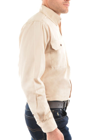A man, shown from the side against a white background, wears a beige Thomas Cook Heavy Drill Half Placket Shirt with long sleeves and dark blue jeans paired with a black belt.