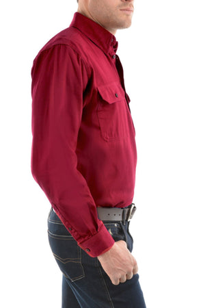 A man in a Thomas Cook Heavy Drill Half Placket Shirt with chest pockets, blue jeans, and a black belt, shown from the side against a white background.