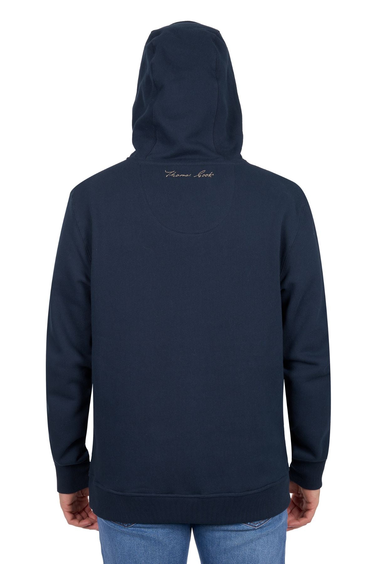 A person wearing the Thomas Cook Heritage Oval Hoodie in navy blue and blue jeans is facing away from the camera. Subtle cursive text decorates the upper back of the hoodie near the neckline.