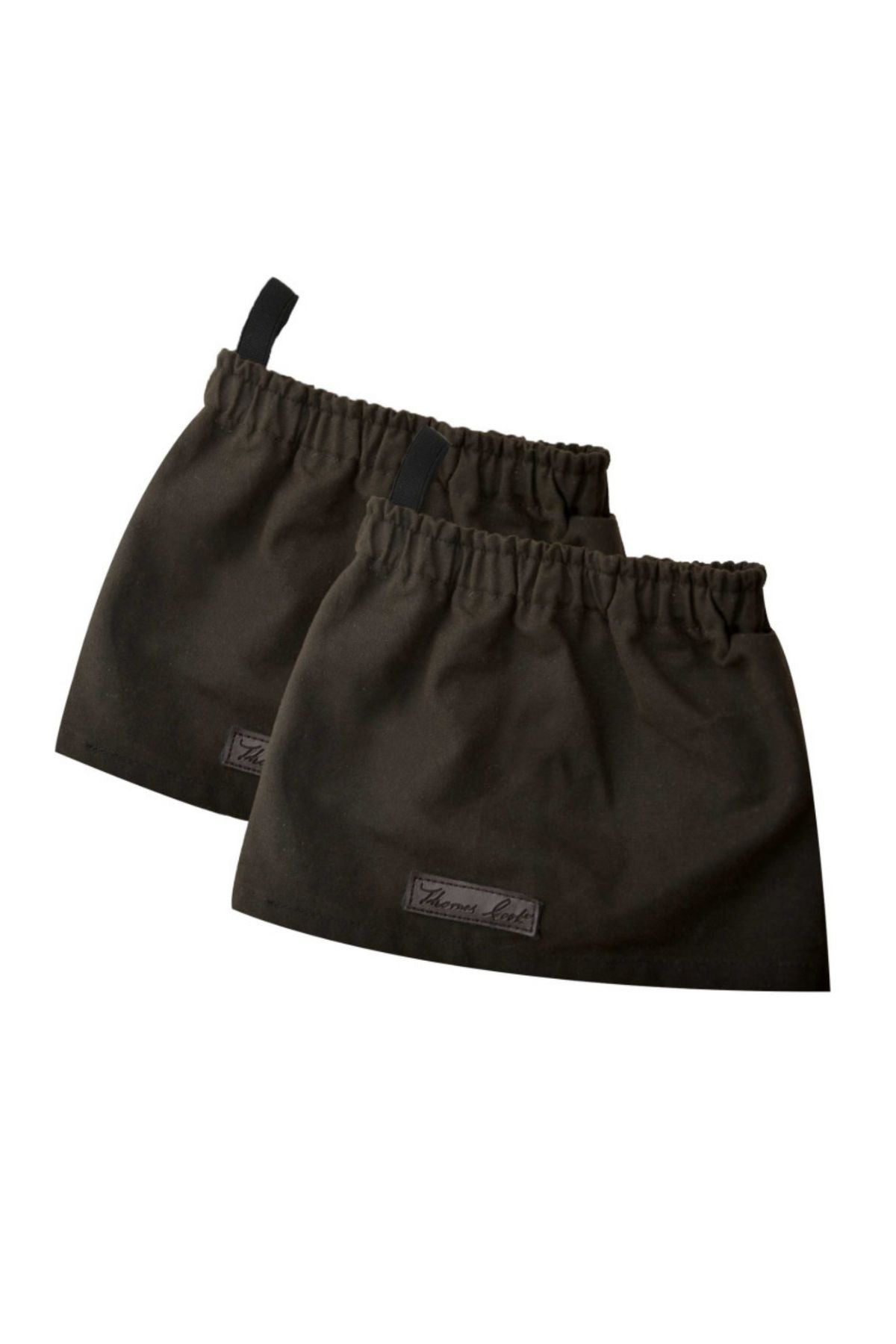 The Thomas Cook High Country Bushman Short Oilskin Gaiters are dark, fabric gaiters with elastic bands and small loops, offering outdoor protection for the lower legs. Each features a small rectangular label.