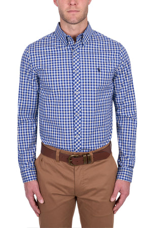 A man wears the Thomas Cook James Tailored Shirt in blue and white checks, tucked into khaki pants with a brown belt, standing against a plain white background.