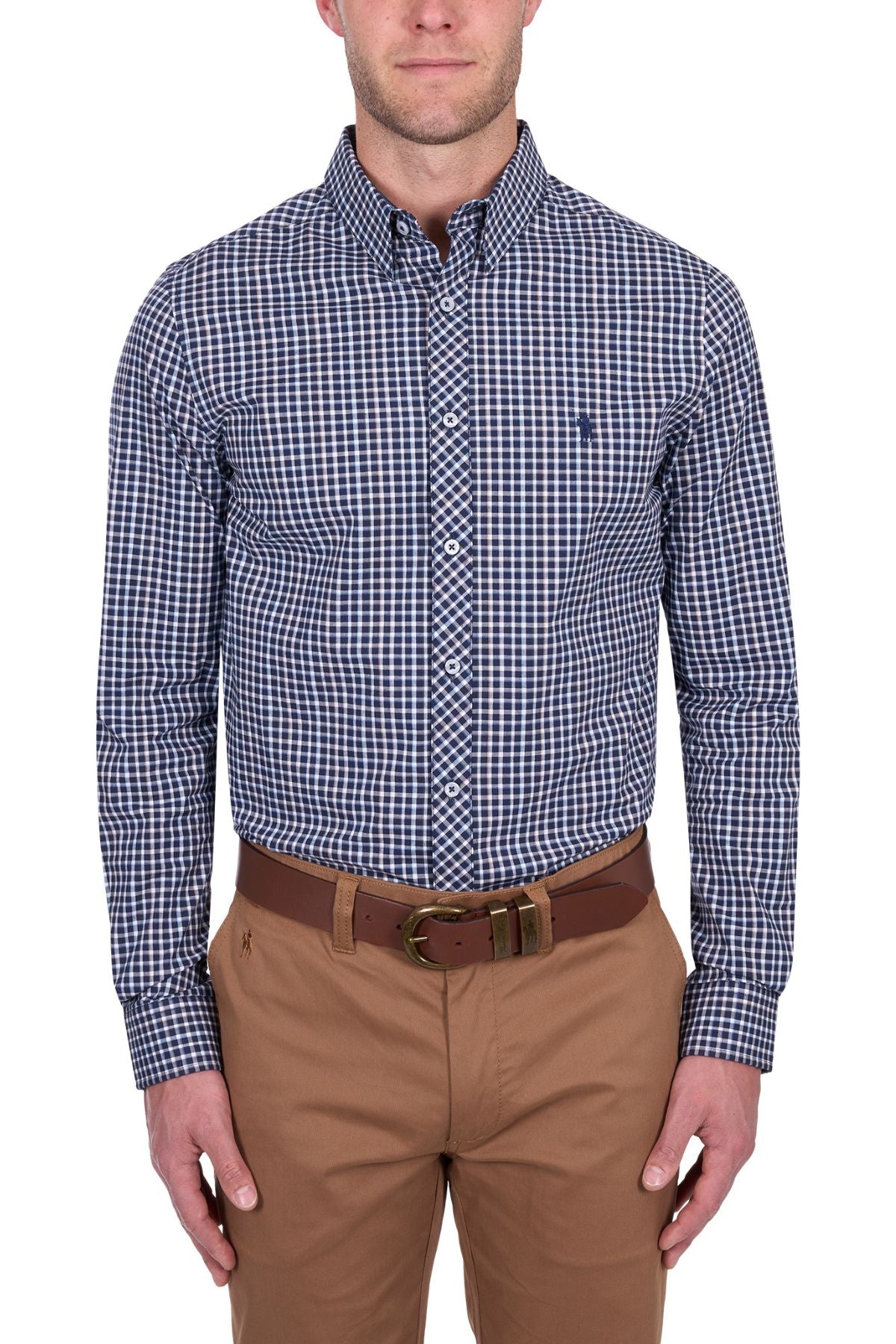A man wearing the Thomas Cook Jason Tailored Shirt, a blue and white checkered long sleeve, tucked into tan pants with a brown belt, stands against a white background. His head is partially cropped out of the image.