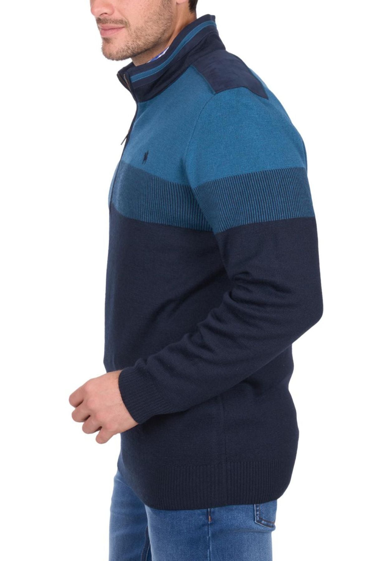 A man in side profile wears a Thomas Cook Jerry 1/4 Zip Jumper in blue/navy, made from Australian merino wool, paired with blue jeans against a white background.