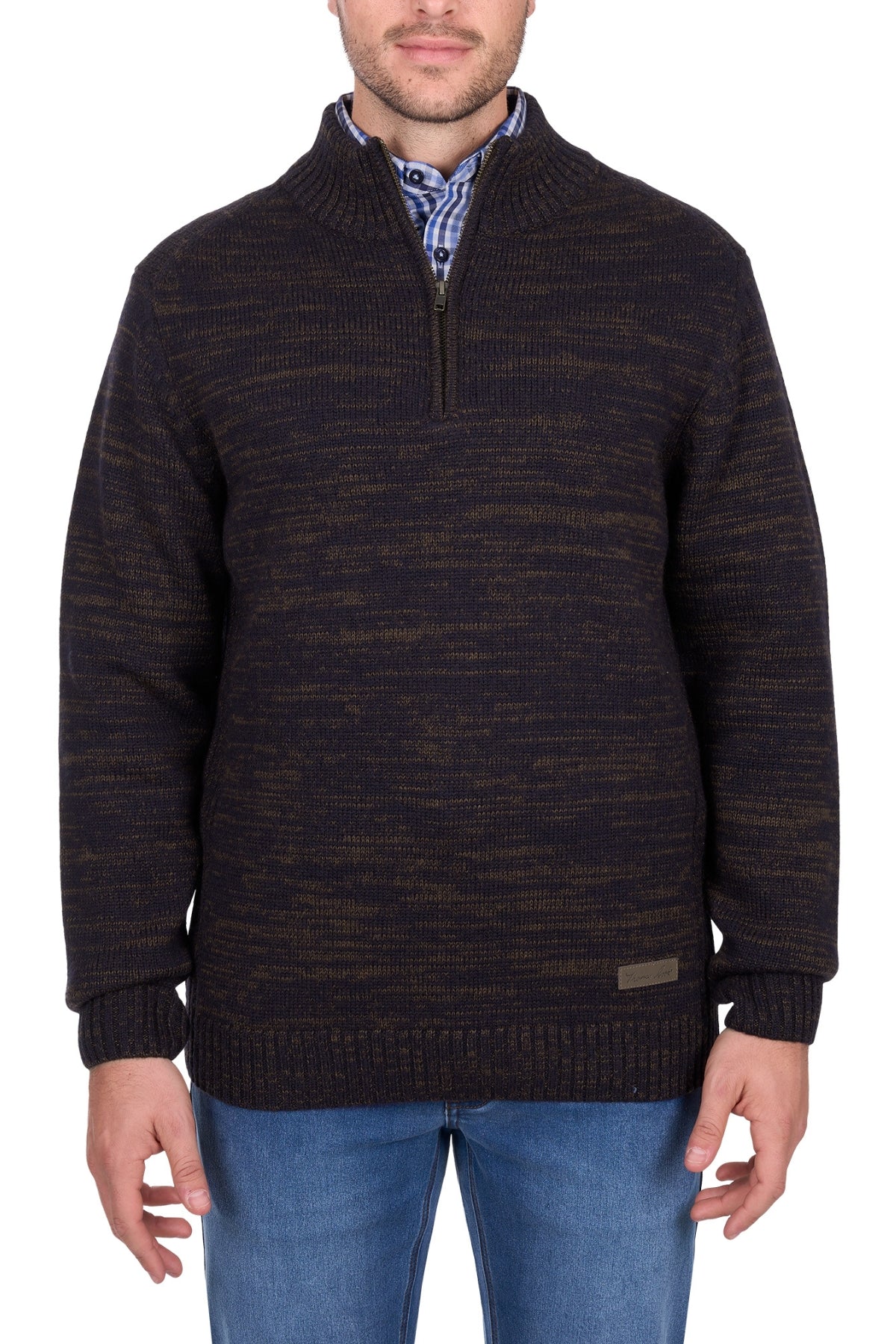 A man wearing the Thomas Cook Jesse 1/4 Zip Jumper, a dark brown and black marled heavyweight wool sweater, over a plaid shirt with blue jeans, stands against a white background.