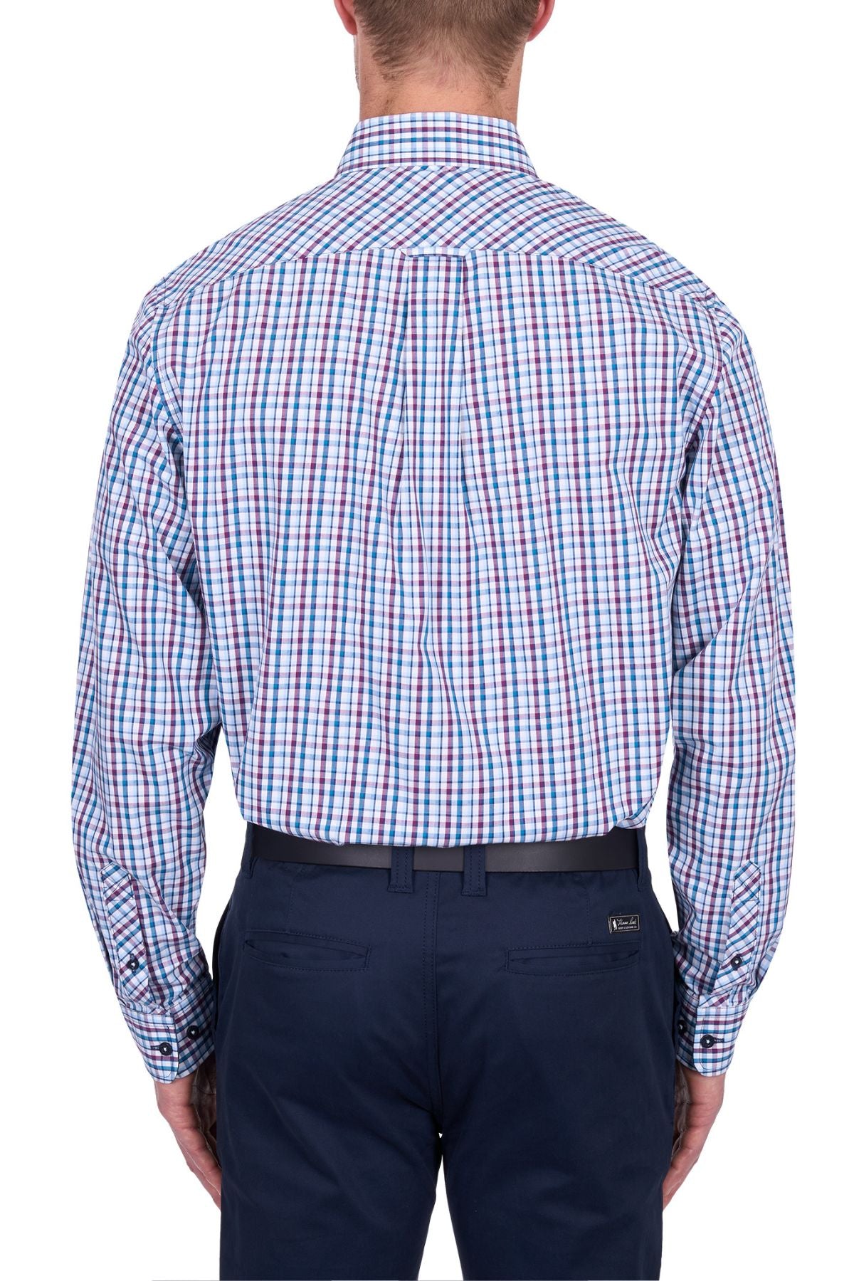 A man seen from behind wearing the Thomas Cook Joseph Shirt, a long-sleeved blue, red, and white checkered 100% cotton button-down, tucked into navy pants with a black belt.
