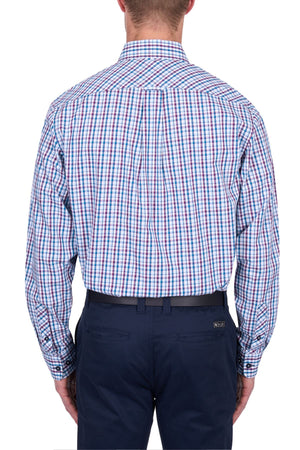A man seen from behind wearing the Thomas Cook Joseph Shirt, a long-sleeved blue, red, and white checkered 100% cotton button-down, tucked into navy pants with a black belt.