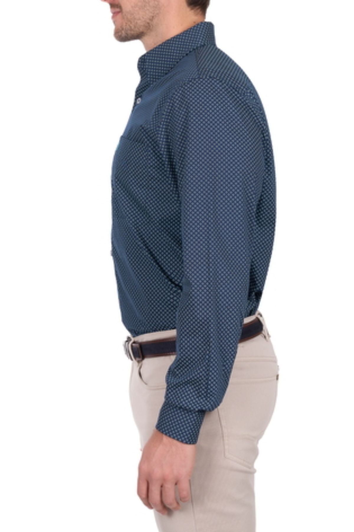A man in a blue patterned Thomas Cook Kevin Shirt and beige pants stands in profile facing left, arms relaxed at his side.
