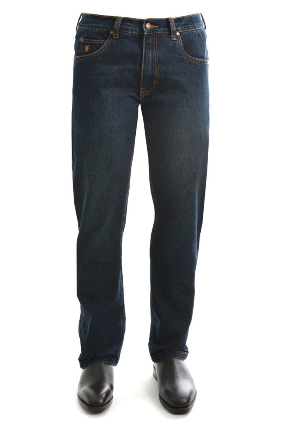 The Thomas Cook Lochie Tailored Jean in dark blue stretch denim is shown from the front, paired with brown leather shoes. These jeans feature classic stitching, front pockets, and a button waist closure.