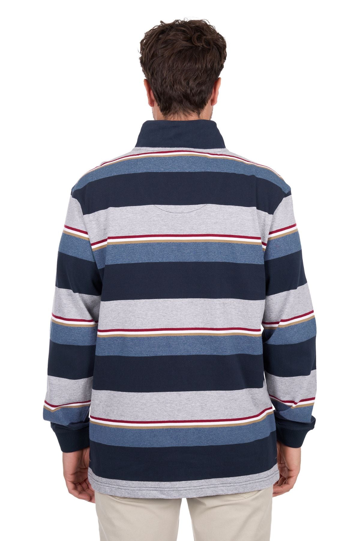 A person with short brown hair is facing away from the camera, wearing the Thomas Cook Nathan 1/4 Zip Rugby featuring wide navy, gray, white, and red stripes, paired with light-colored pants.