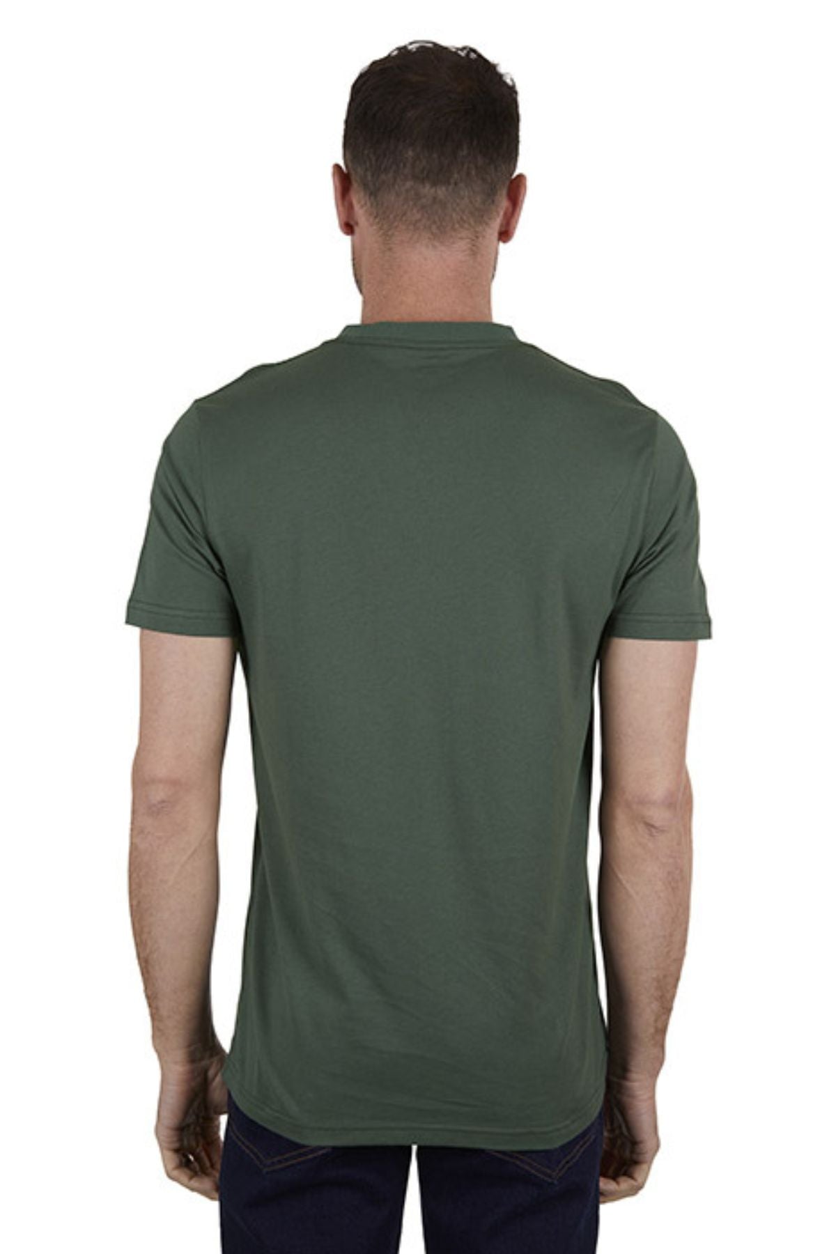 A man faces away from the camera, wearing a Thomas Cook Oval Tee—classic fit, 100% cotton, dark green—with dark pants, set against a plain white background.