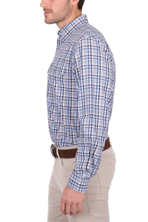 A man in a blue and white plaid Thomas Cook Patrick Shirt with beige pants stands in profile against a white background.