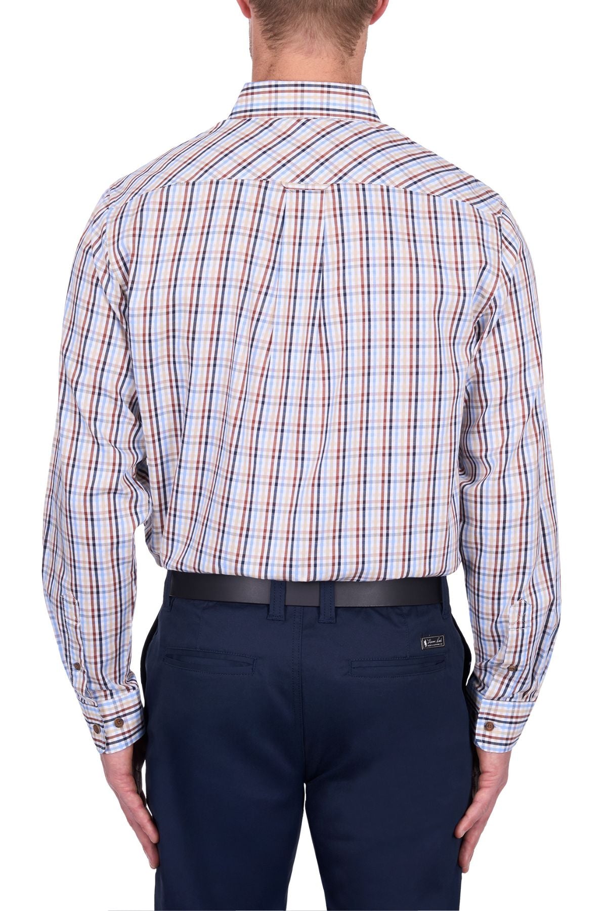 A man is seen from the back wearing a Thomas Cook Scott Shirt, a long-sleeve, 100% cotton multicolored plaid shirt, tucked into navy trousers with a black belt against a white background.