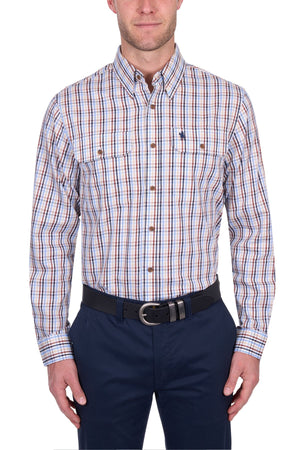 A man wears a Thomas Cook Scott Shirt—100% cotton, long sleeve, with blue, red, and white plaid—tucked into navy blue pants and a black belt. The image is cropped at the head and legs.